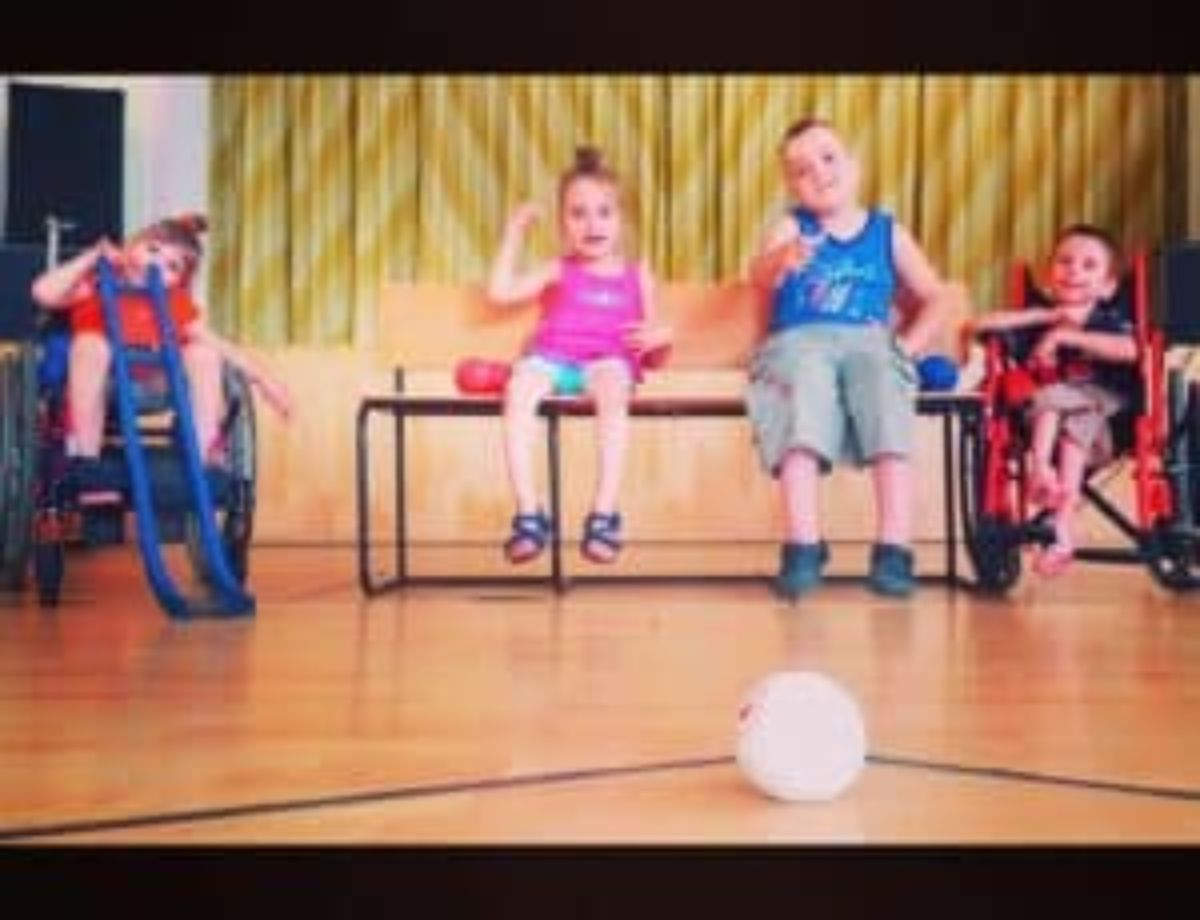 Small children playing boccia