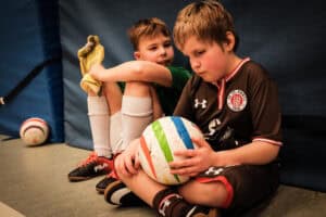 Visually impaired boy with Rainbow blind football