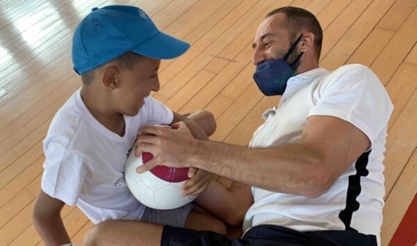 Child and adult playing with Rattle ball - Real Eyes Sport, Italy